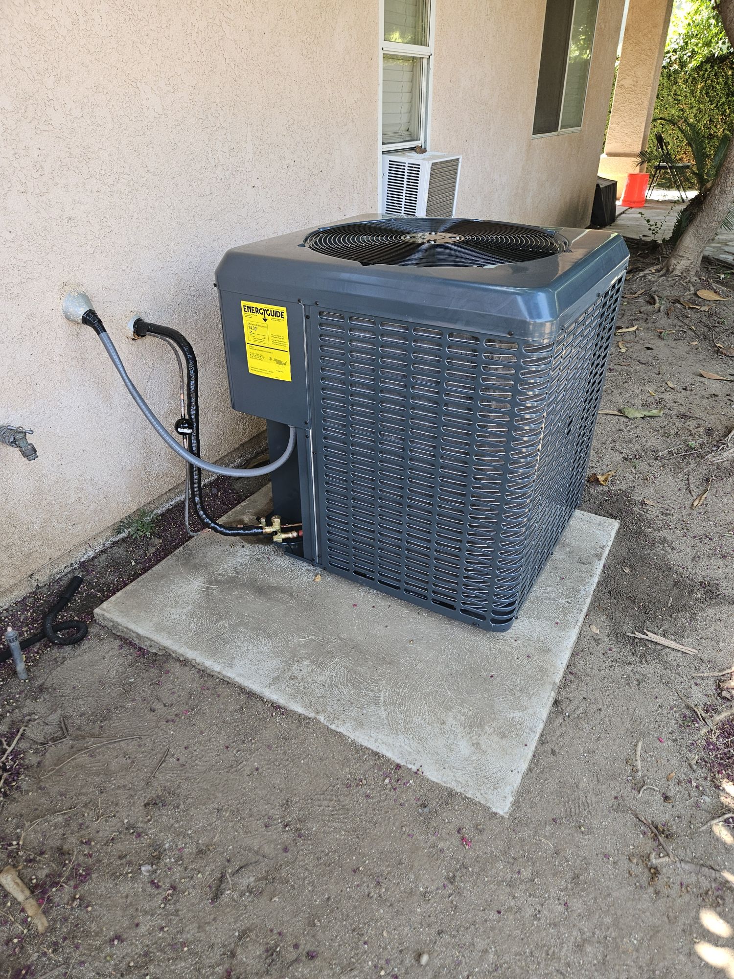 New AC condenser installation in Clovis backyard