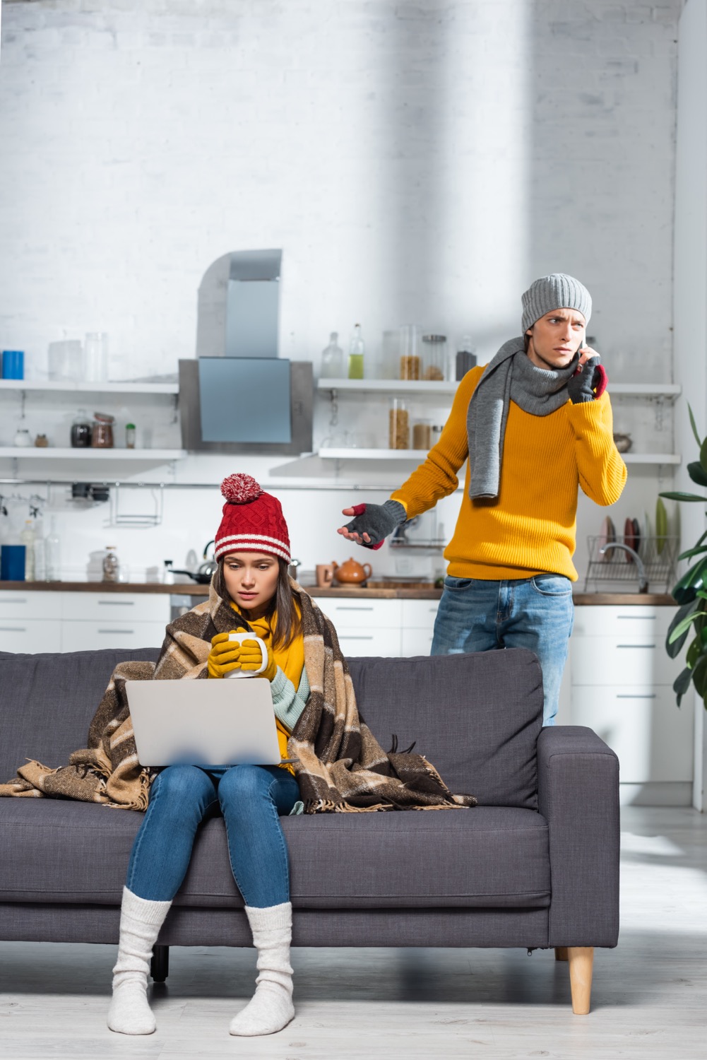 freezing woman sitting on sofa with laptop while w 2024 11 09 18 55 54 utc