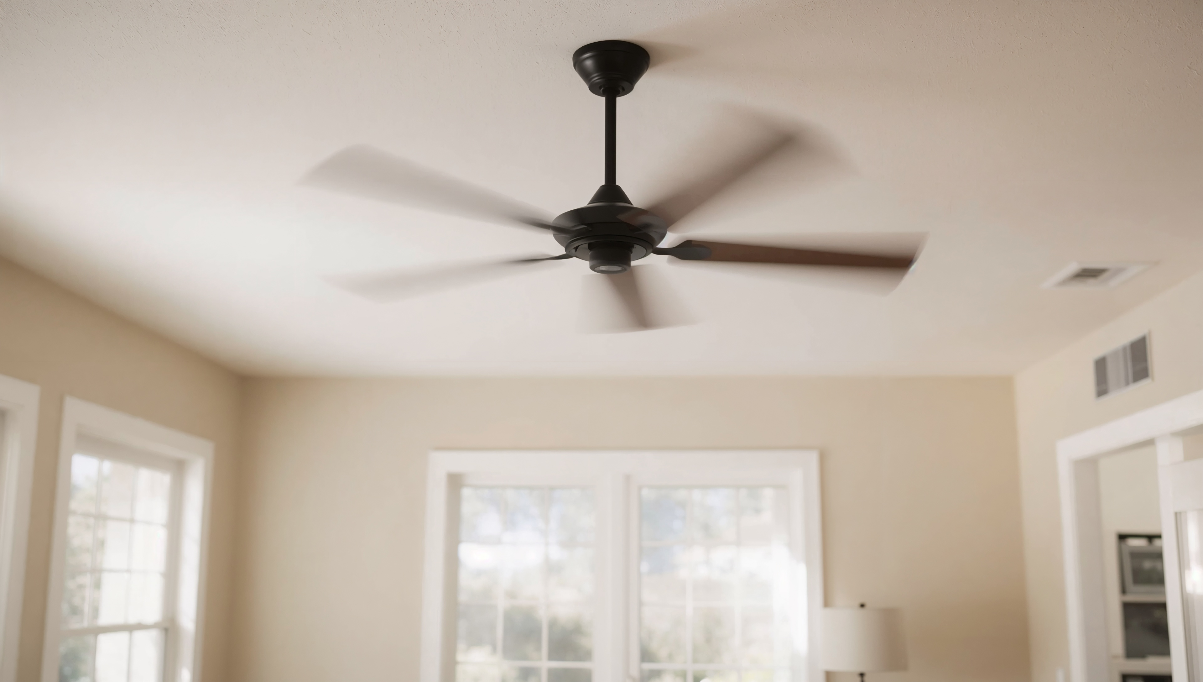 Ceiling fan spinning counterclockwise in a spacious, naturally lit Central Valley living room.